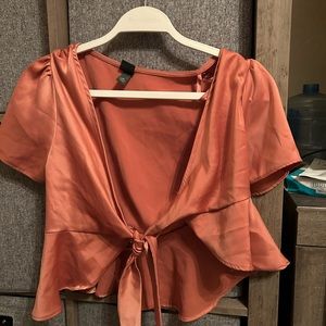 Pink blouse. Ties at the front.